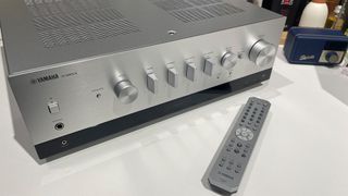 Yamaha R-N800A streaming amplifier on white surface next to remote control