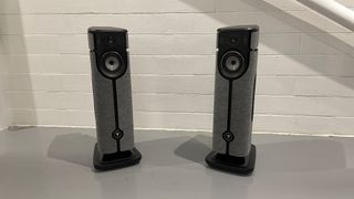 Focal Diva Utopia all-in-one stereo system on grey floor in front of white brick wall